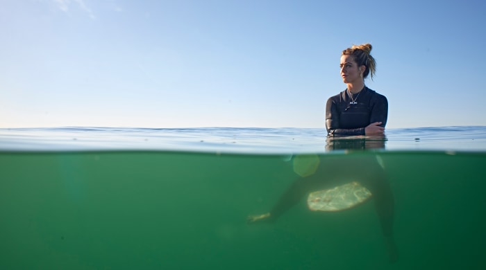 Caroline Marks on her surfboard.